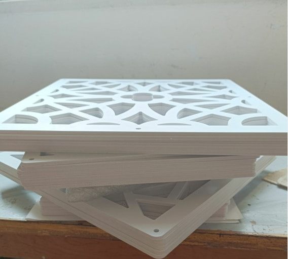 Stack of white decorative panels showing edge and thickness